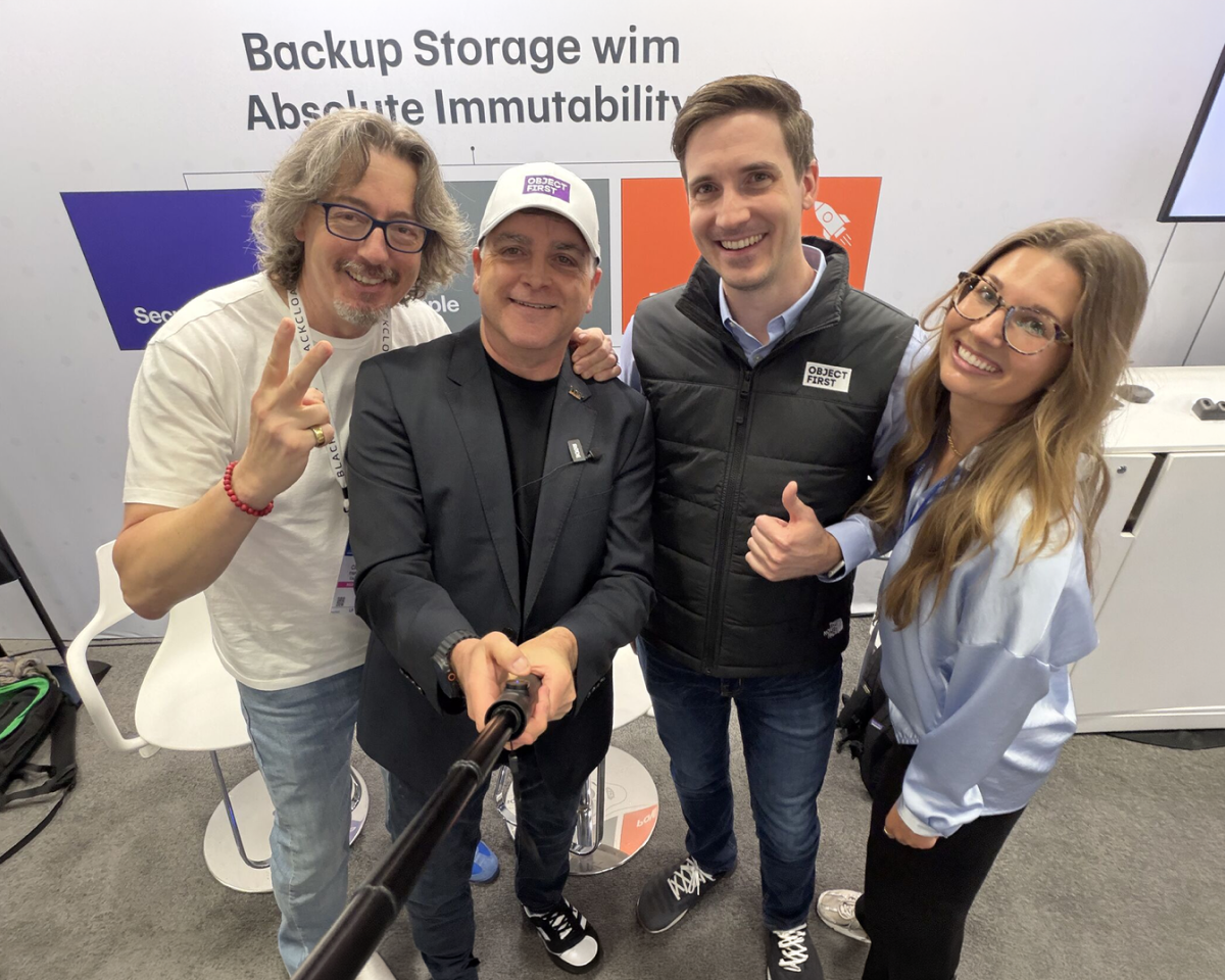 Object First colleagues taking a group selfie at a conference booth