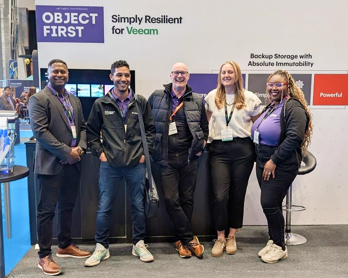 Object First team members standing together at a conference booth